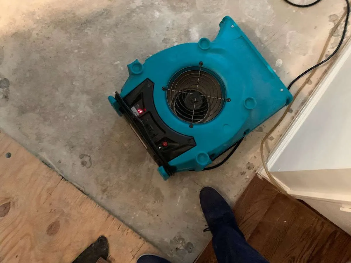 Air mover drying subfloor during Commercial Water Damage Restoration in Newfane